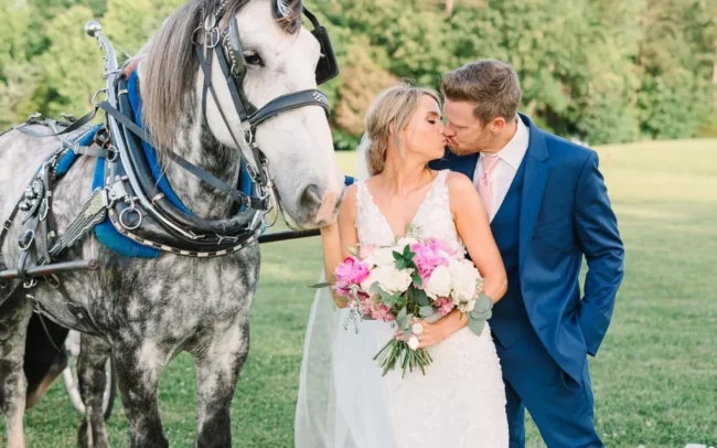 Bride and groom next to a horse